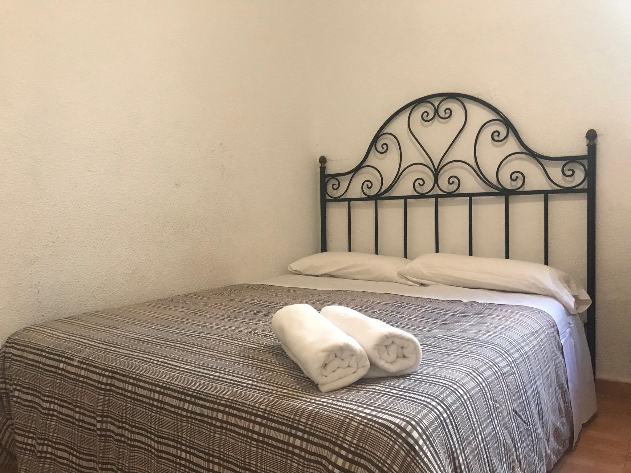 Hostal Los Perales Madrid Exterior photo A bed with a wrought iron headboard
